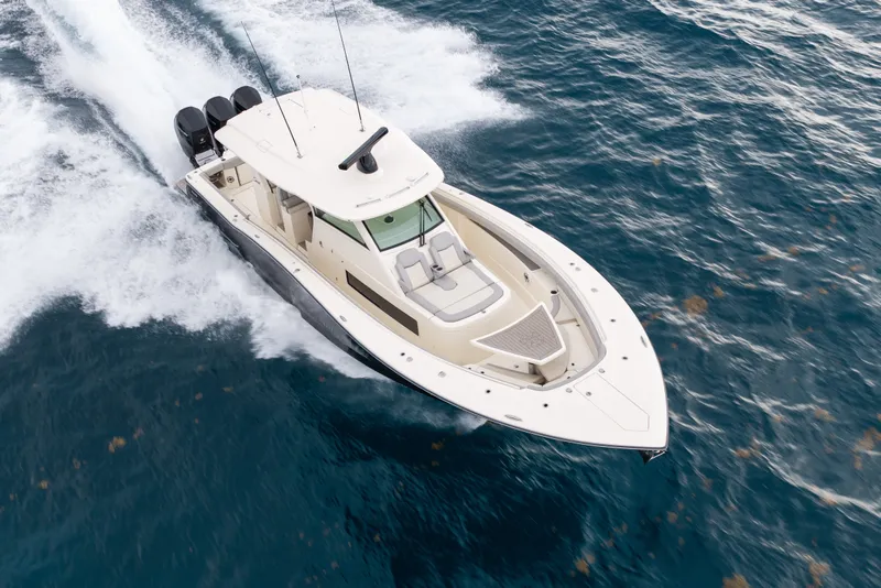 Slide: The Image of 2022 Scout 425 LXF boat cruising on open water, showcasing sleek design and powerful engines. - 2
