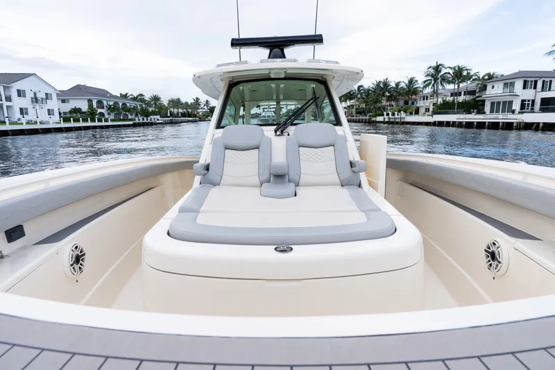 Slide: The Image of 2022 Scout 425 LXF boat with luxurious seating on a scenic waterway. - 11