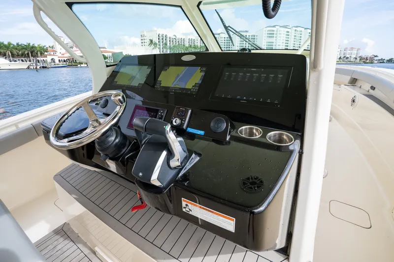 Slide: The Image of Helm of 2022 Scout 425 LXF boat with advanced navigation displays and controls. - 21