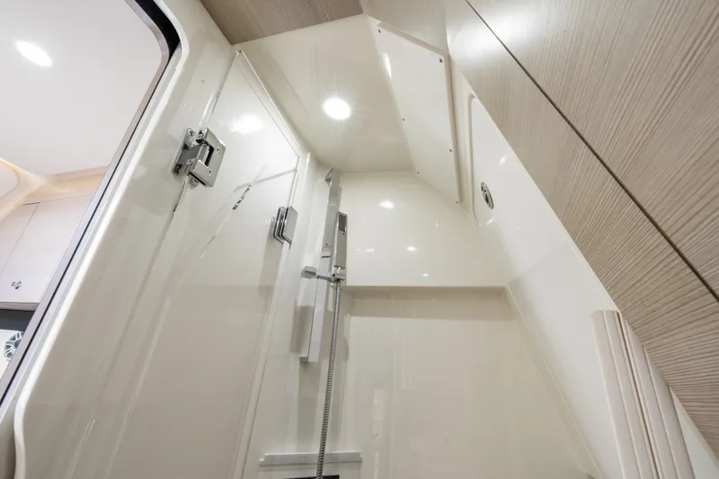 Slide: The Image of Interior of 2022 Scout 425 LXF boat, featuring modern shower area with sleek design. - 33