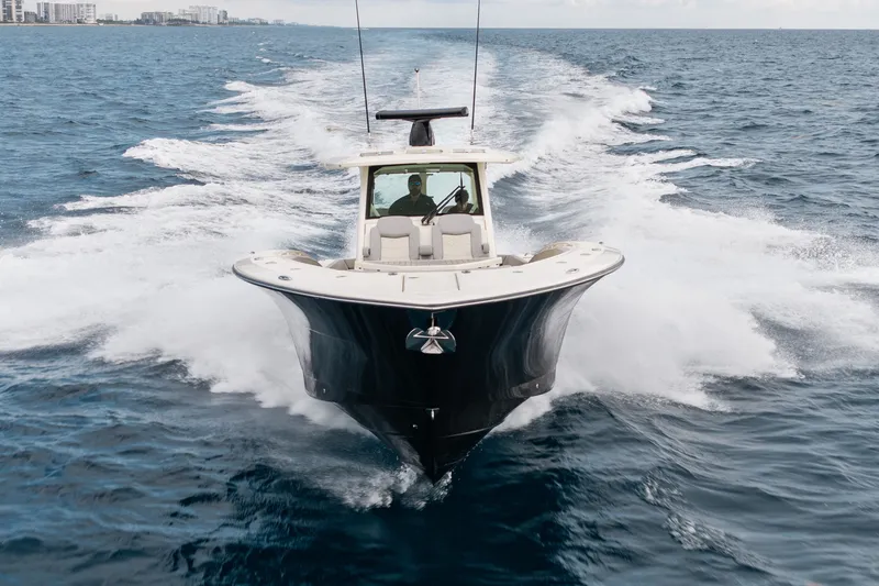 Slide: The Image of 2022 Scout 425 LXF boat cruising on open ocean waters. - 38