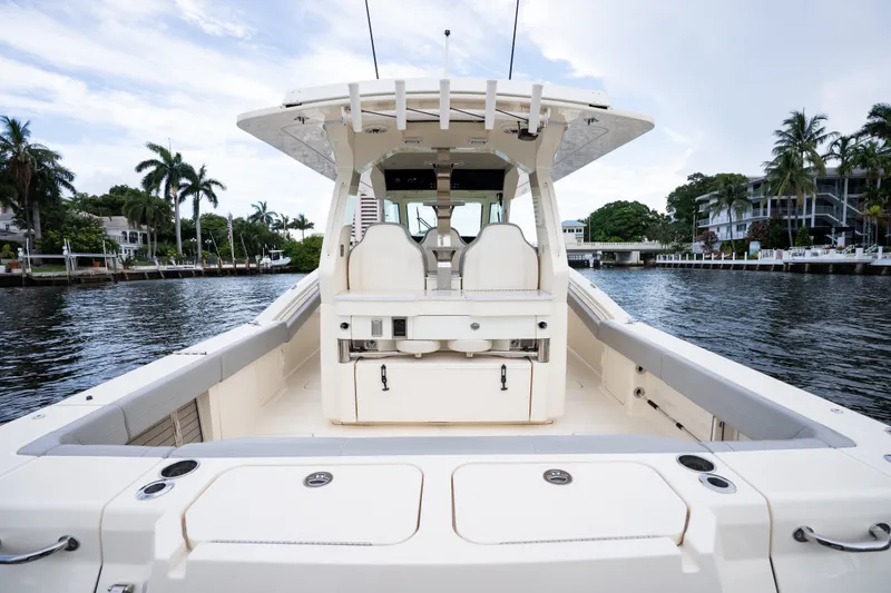 Slide: The Image of 2022 Scout 425 LXF boat on water, showcasing spacious deck and luxurious seating. - 16