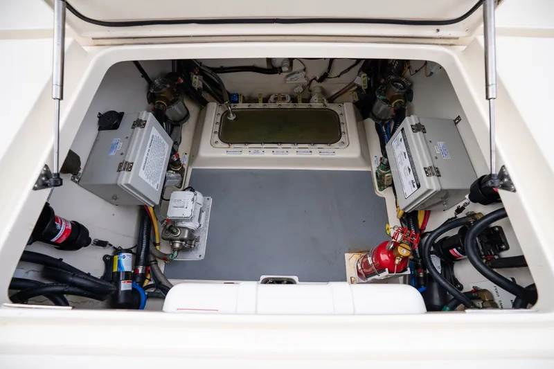 Slide: The Image of Engine compartment of 2022 Scout 425 LXF boat, showcasing electrical systems and fire extinguisher. - 28