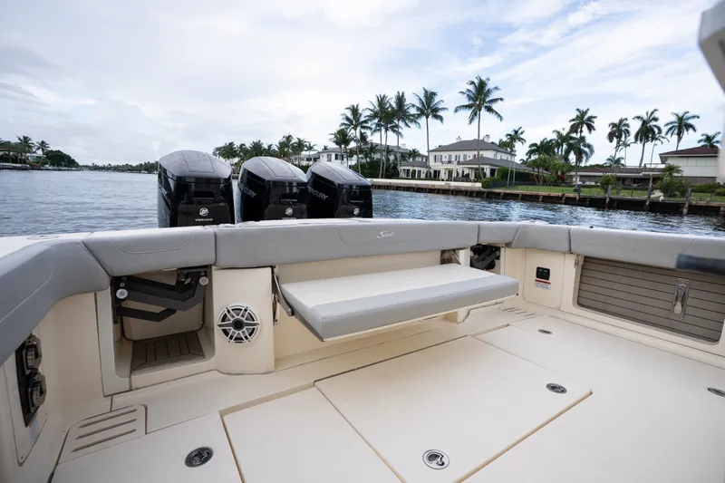 Slide: The Image of 2022 Scout 425 LXF boat interior with seating, outboard engines, and waterfront view. - 18