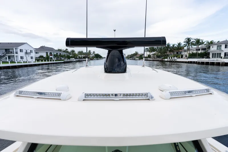Slide: The Image of 2022 Scout 425 LXF boat on a serene waterway, showcasing sleek design and advanced features. - 12