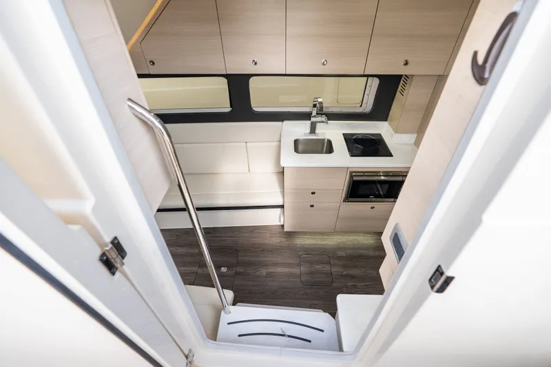 Slide: The Image of Interior view of 2022 Scout 425 LXF yacht kitchen with modern cabinetry and appliances. - 36