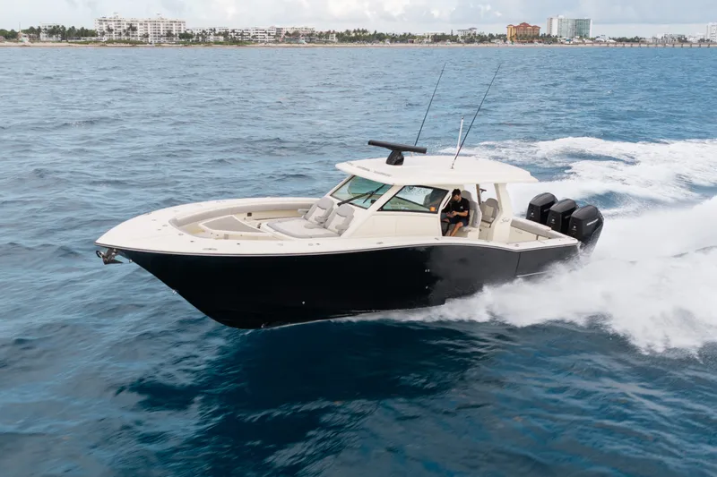 Slide: The Image of 2022 Scout 425 LXF boat cruising on open water, showcasing sleek design and powerful engines. - 1