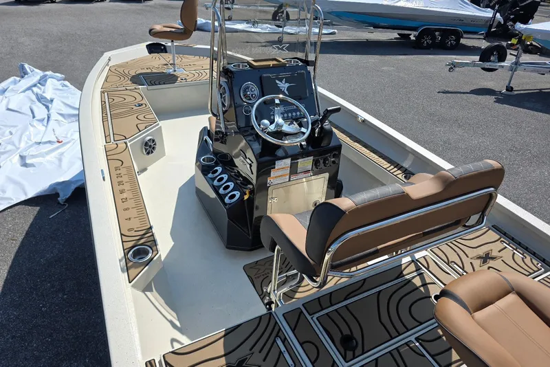 Slide: The Image of 2027 Xpress H22B Bay boat interior with steering console and seating. - 5