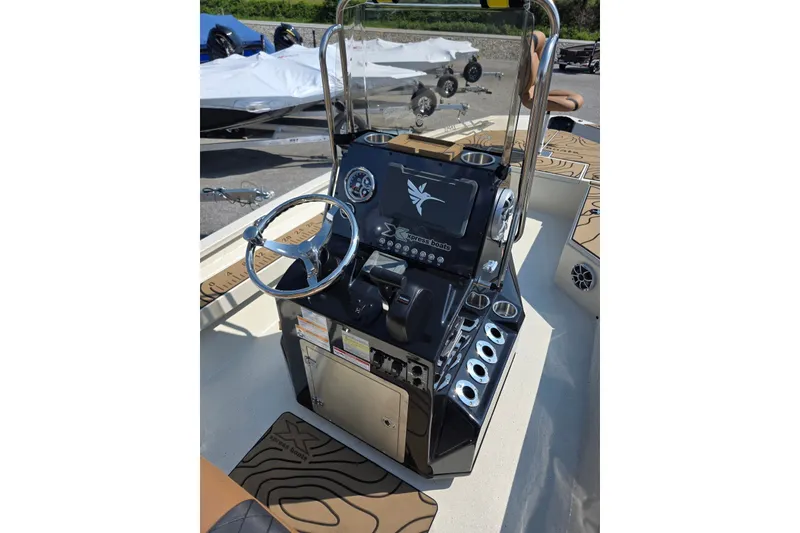 Slide: The Image of Console of 2027 Xpress H22B Bay boat with steering wheel and controls. - 11