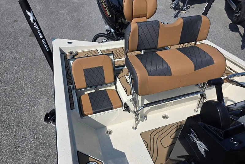 Slide: The Image of 2027 Xpress H22B Bay boat interior with tan and black seating, featuring sleek design and comfort. - 10