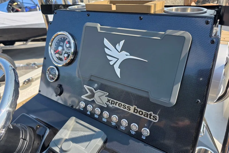 Slide: The Image of Dashboard of 2027 Xpress H22B Bay boat with logo and gauges. - 13