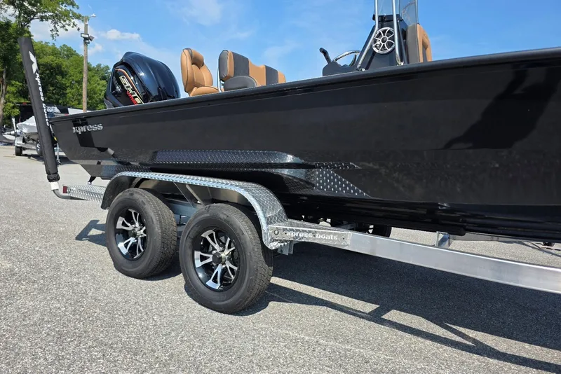 Slide: The Image of 2027 Xpress H22B Bay boat on trailer, featuring sleek black design and modern wheels. - 2