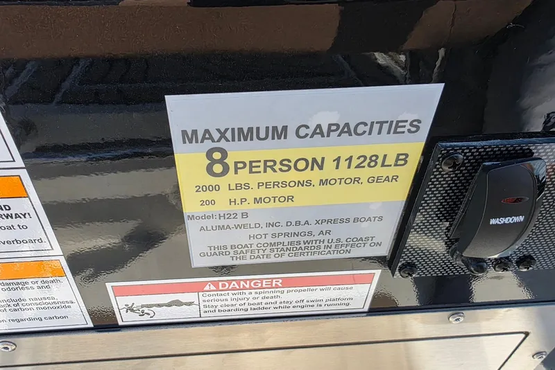 Slide: The Image of Xpress H22B Bay 2027 boat capacity label, 8 persons, 1128 lbs, 200 HP motor. - 12