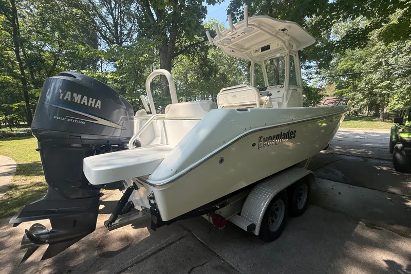 Slide: The Image of 2011 Everglades 230 Center Console boat with Yamaha engine on trailer, parked outdoors. - 5