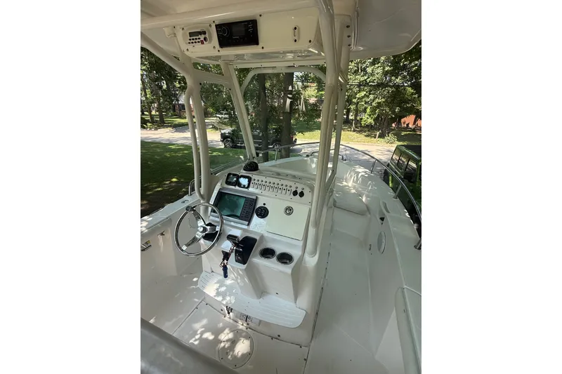 Slide: The Image of 2011 Everglades 230 Center Console boat interior with steering wheel and navigation equipment. - 13