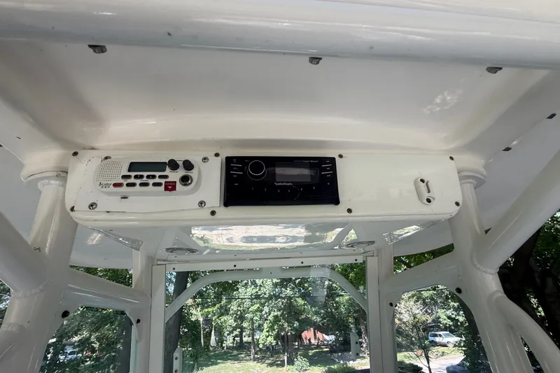 Slide: The Image of 2011 Everglades 230 Center Console boat dashboard with radio and control panel. - 16