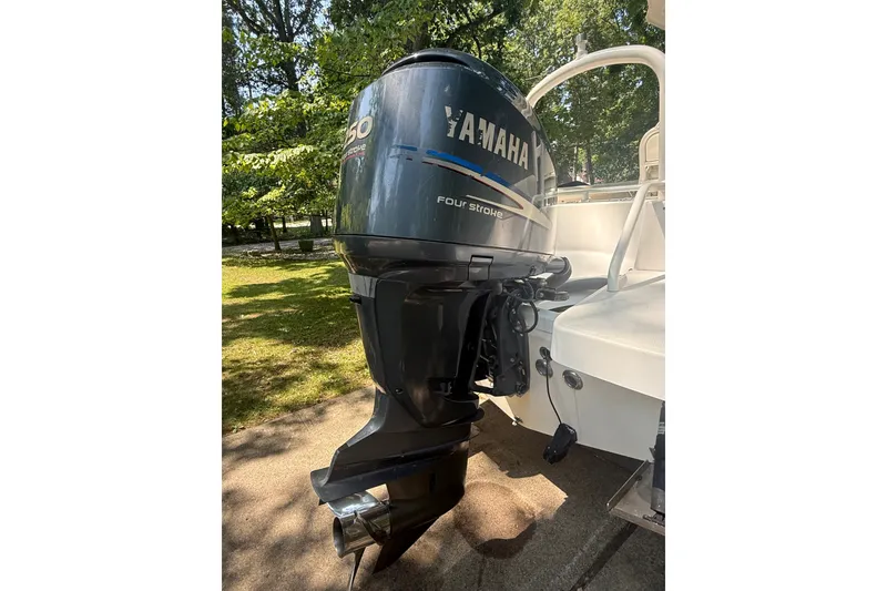 Slide: The Image of 2011 Everglades 230 Center Console with Yamaha outboard motor in a sunny outdoor setting. - 6