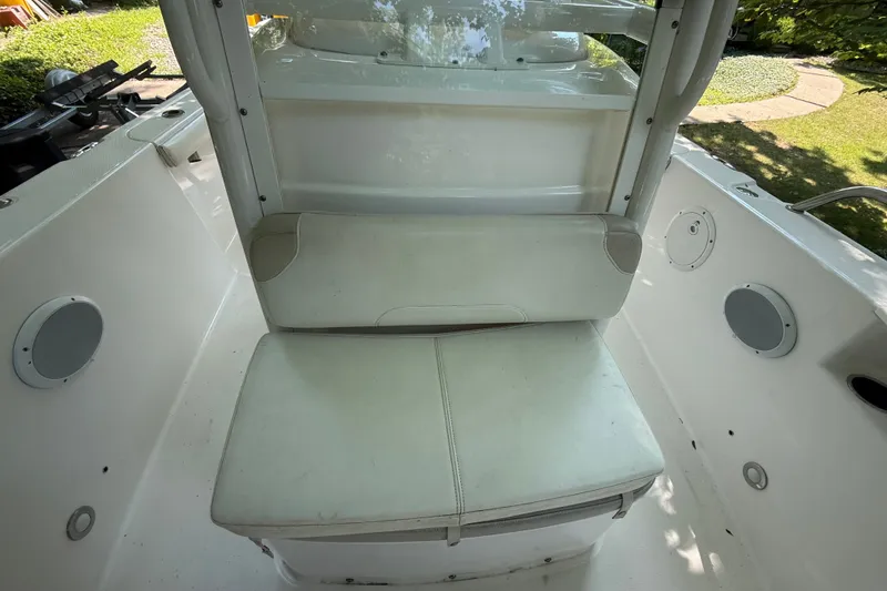 Slide: The Image of 2011 Everglades 230 Center Console boat interior with white seating and storage compartments. - 20