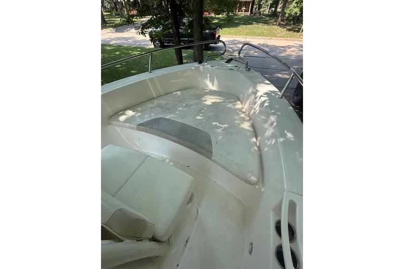 Slide: The Image of 2011 Everglades 230 Center Console boat interior with seating and railings. - 18