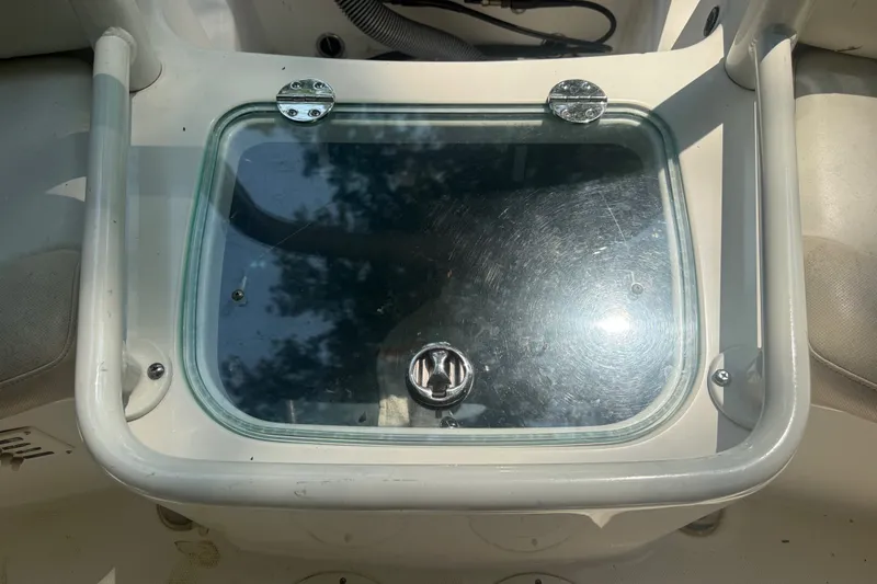 Slide: The Image of Glass hatch on 2011 Everglades 230 Center Console boat, reflecting sunlight. - 12
