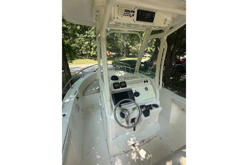 Slide: The Image of 2011 Everglades 230 Center Console boat interior with steering wheel and control panel. - 14