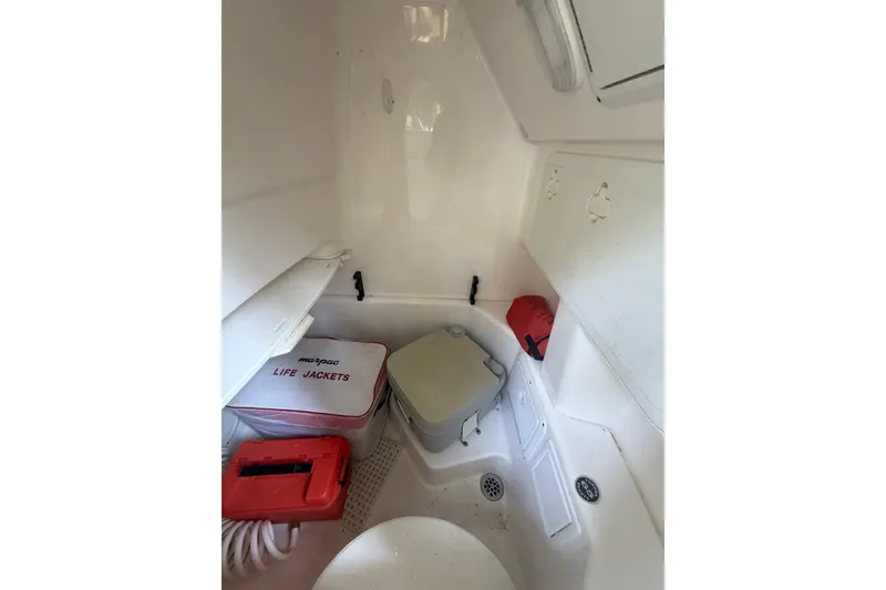 Slide: The Image of Interior of 2011 Everglades 230 Center Console boat with life jackets and safety equipment. - 21
