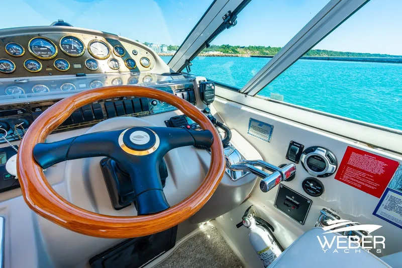 Slide: The Image of Cockpit of 2001 Cruisers Yachts 3870 Express with wooden steering wheel and control panel. - 30