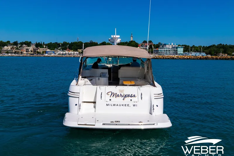 Slide: The Image of 2001 Cruisers Yachts 3870 Express on water, Milwaukee backdrop, sunny day. - 10