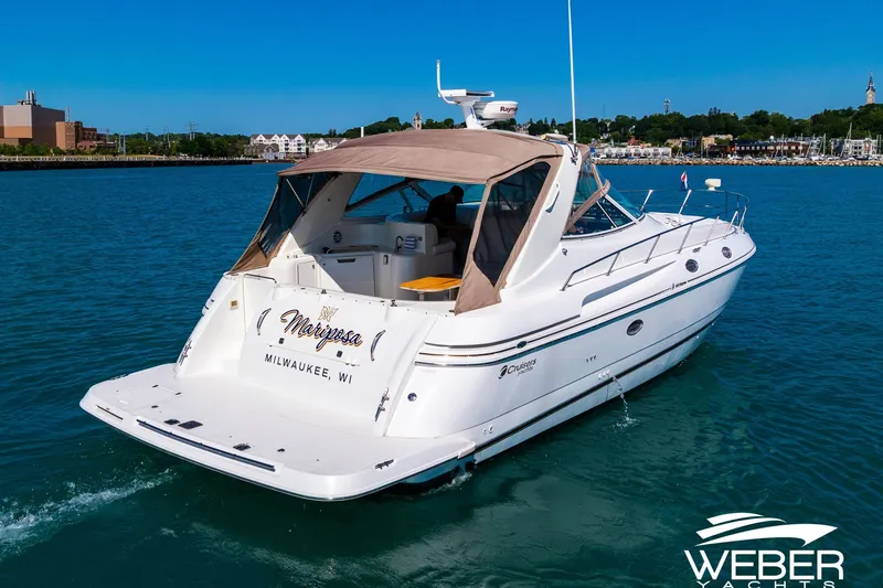 Slide: The Image of 2001 Cruisers Yachts 3870 Express on Milwaukee waters, featuring sleek design and spacious deck. - 9