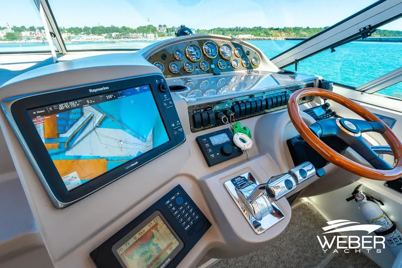 Slide: The Image of Cockpit of 2001 Cruisers Yachts 3870 Express with navigation equipment and steering wheel. - 29