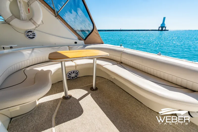 Slide: The Image of Luxurious 2001 Cruisers Yachts 3870 Express interior with elegant seating and ocean view. - 18