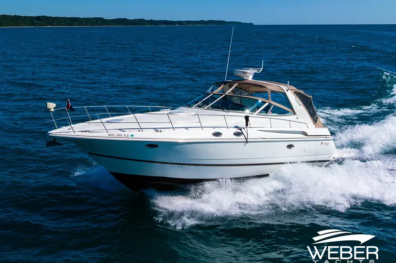 Slide: The Image of 2001 Cruisers Yachts 3870 Express cruising on open water, showcasing sleek design and performance. - 1