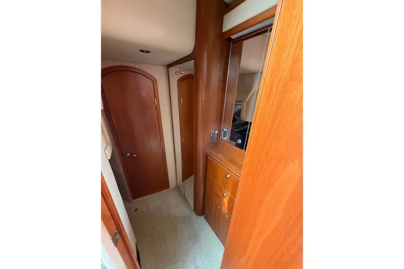Slide: The Image of Interior hallway of 2001 Cruisers Yachts 3870 Express, featuring wooden cabinetry and doors. - 24
