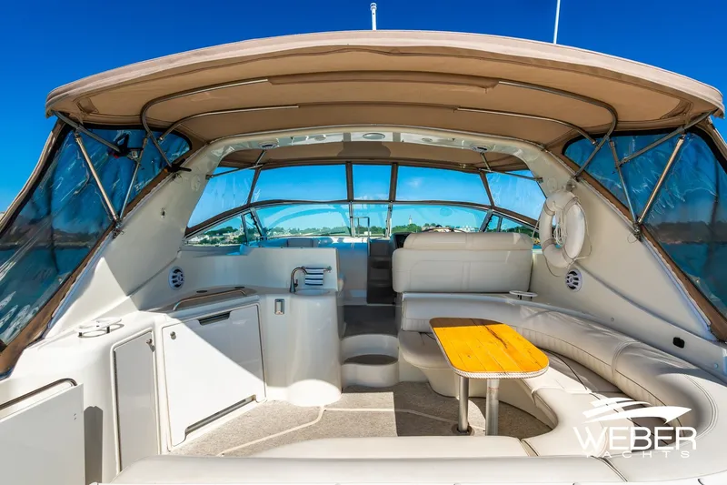Slide: The Image of 2001 Cruisers Yachts 3870 Express interior with seating and table under canopy. - 17