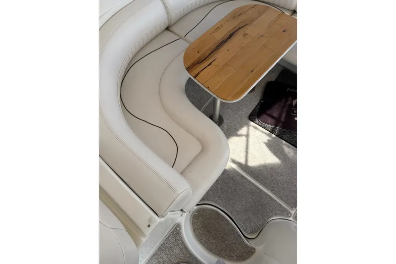 Slide: The Image of 2001 Cruisers Yachts 3870 Express interior with curved seating and wooden table. - 11