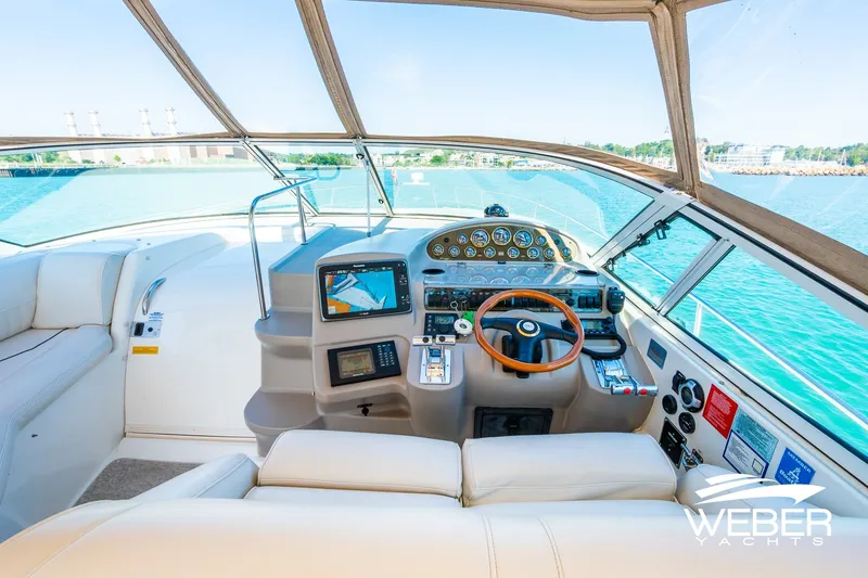 Slide: The Image of Luxurious 2001 Cruisers Yachts 3870 Express helm with modern navigation equipment and panoramic views. - 23