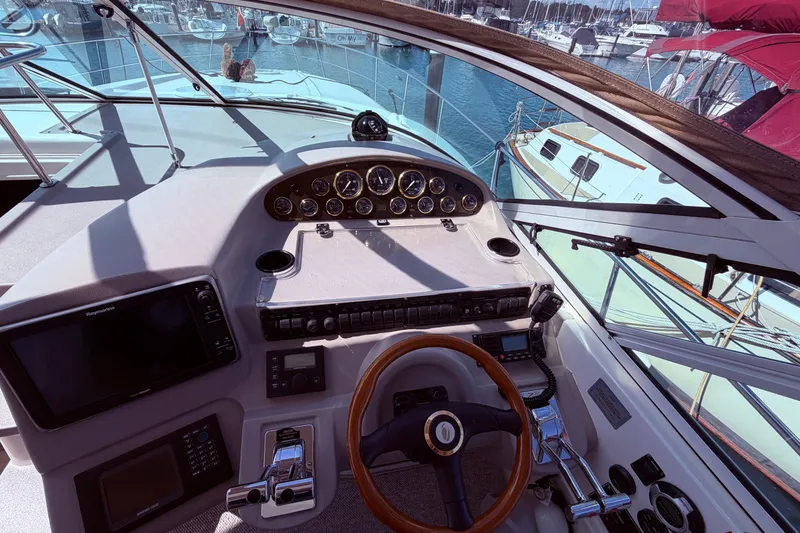 Slide: The Image of Cockpit view of a 2001 Cruisers Yachts 3870 Express, featuring navigation instruments and steering wheel. - 15