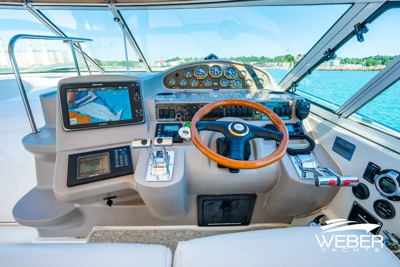 Slide: The Image of Cockpit of 2001 Cruisers Yachts 3870 Express with navigation equipment and wooden steering wheel. - 25