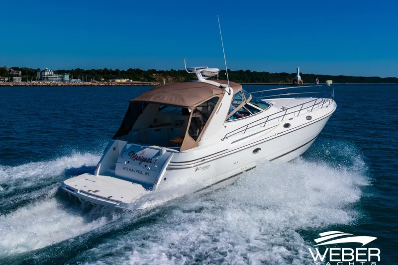 Slide: The Image of 2001 Cruisers Yachts 3870 Express cruising on open water, rear view. - 4