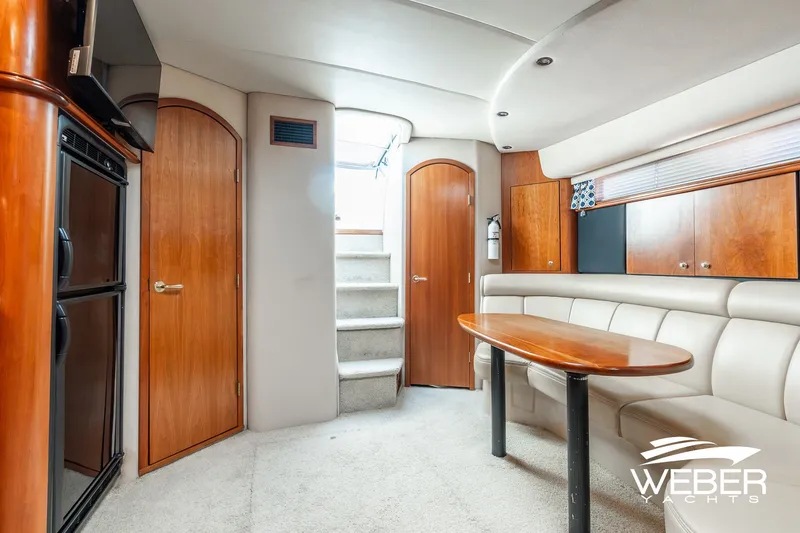 Slide: The Image of Interior of 2001 Cruisers Yachts 3870 Express with elegant wood finishes and plush seating. - 33