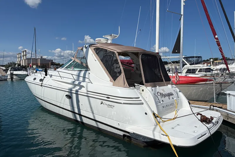 The Image of 2001 Cruisers Yachts 3870 Express docked in a marina under a clear blue sky. - 0