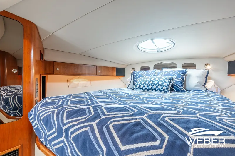 Slide: The Image of Luxurious cabin interior of 2001 Cruisers Yachts 3870 Express with elegant bedding. - 36