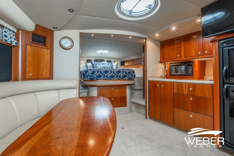 Slide: The Image of Luxurious interior of 2001 Cruisers Yachts 3870 Express with wood cabinetry and cozy seating. - 31
