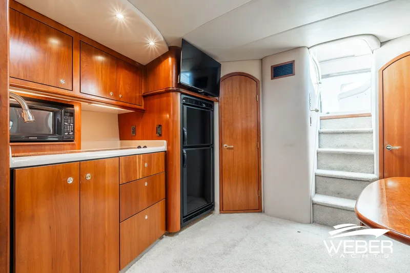 Slide: The Image of Interior of 2001 Cruisers Yachts 3870 Express with wood cabinetry and modern amenities. - 34