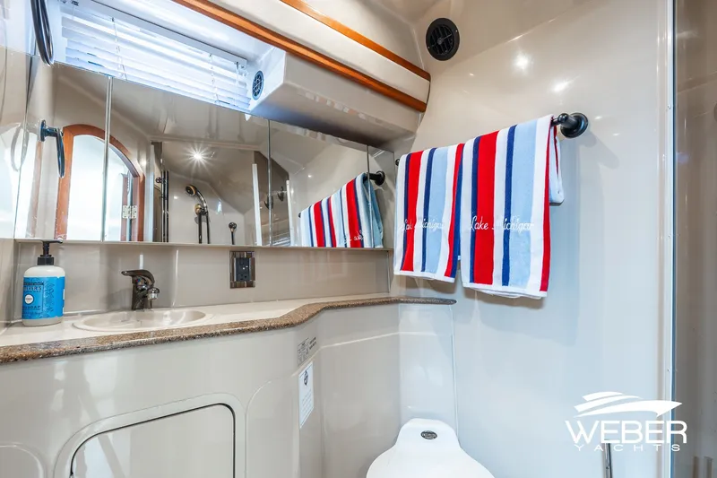 Slide: The Image of Bathroom interior of 2001 Cruisers Yachts 3870 Express with striped towels and modern fixtures. - 41