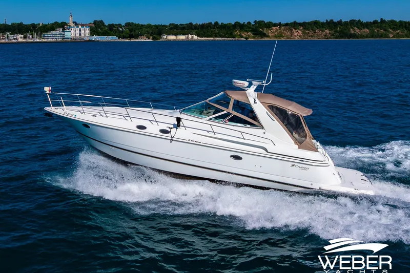 Slide: The Image of 2001 Cruisers Yachts 3870 Express cruising on open water, showcasing sleek design and performance. - 7