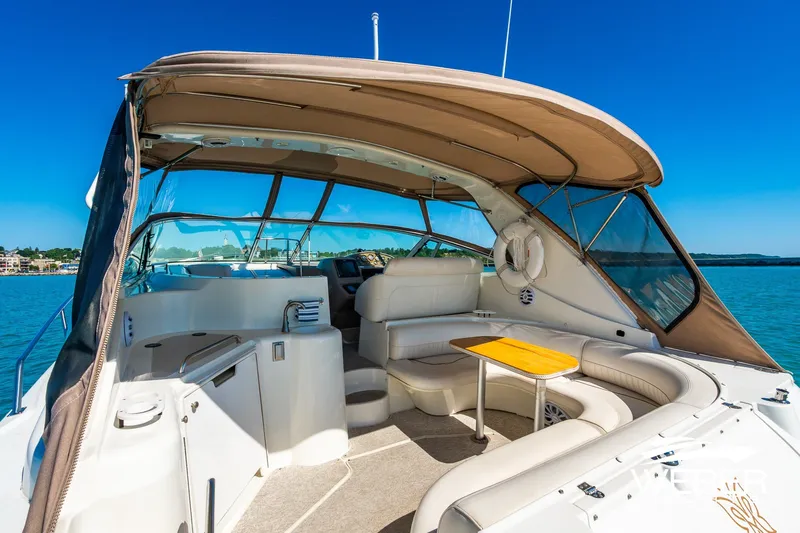 Slide: The Image of 2001 Cruisers Yachts 3870 Express with spacious seating and canopy on a sunny day. - 15