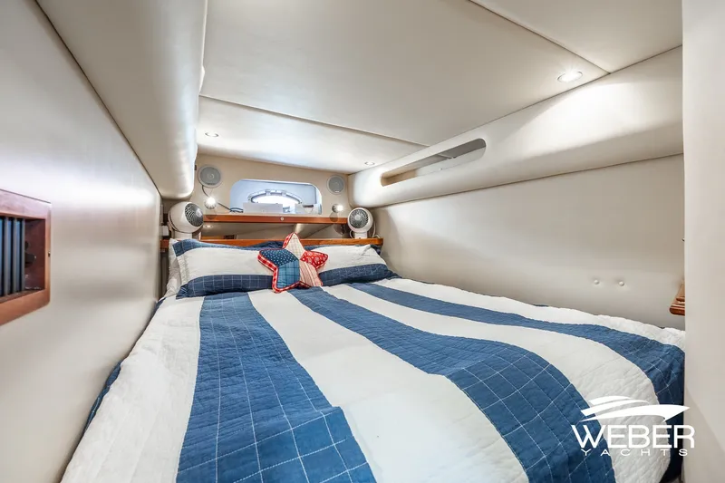 Slide: The Image of Cozy cabin interior of 2001 Cruisers Yachts 3870 Express with nautical bedding. - 40