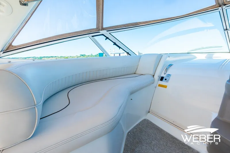 Slide: The Image of 2001 Cruisers Yachts 3870 Express interior with white seating and panoramic windows. - 22