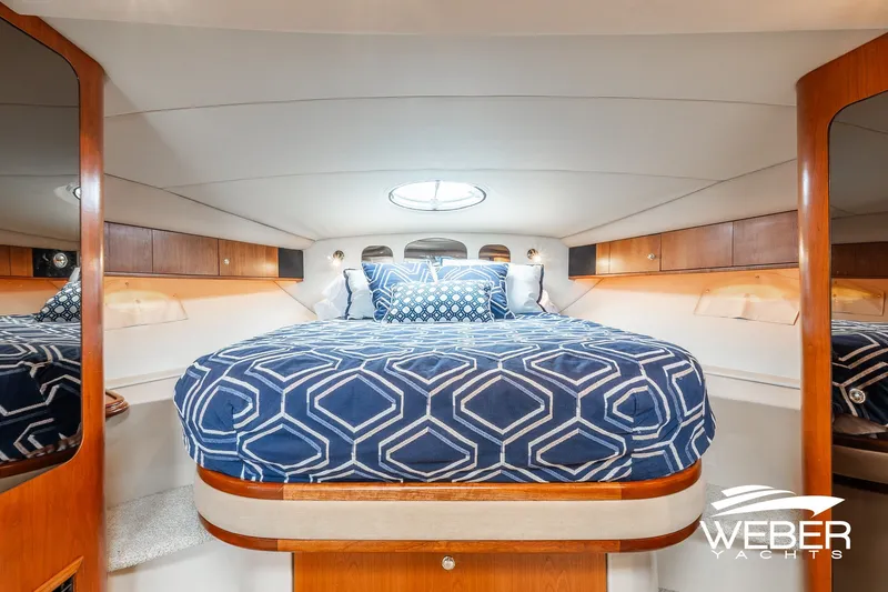 Slide: The Image of Luxurious cabin interior of 2001 Cruisers Yachts 3870 Express with elegant bedding. - 35